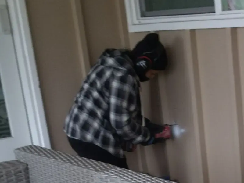 Professional electrician installing an exterior outlet in Watertown